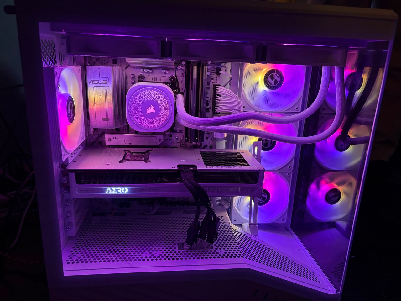 A custom PC built by Amprix: white case, purple lighting, white liquid cooler and a Gigabyte AERO GeForce RTX graphics card