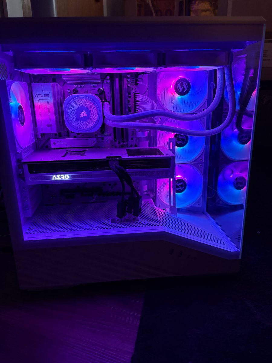 Side view of a custom PC with blue and purple fans, a Corsair liquid cooler, and ASUS motherboard
